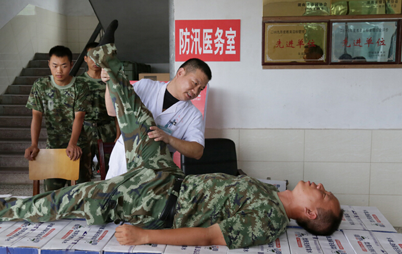 圖為醫(yī)療隊(duì)醫(yī)生在為8730部隊(duì)武警抗洪部隊(duì)官兵進(jìn)行中醫(yī)正骨治療。